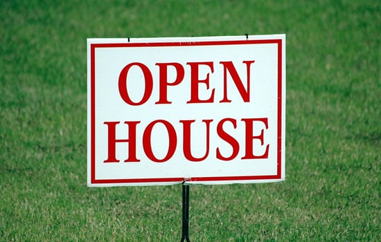 Open House sign on a lawn. Reliant Realty, TN
